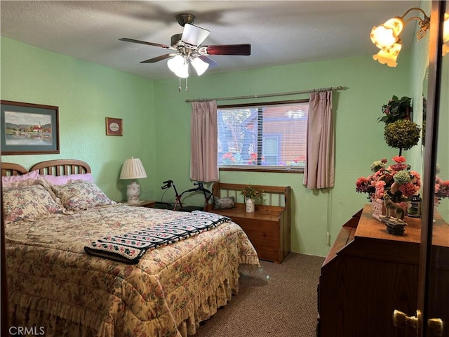 bedroom featuring a ceiling fan and carpet