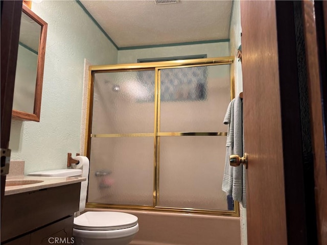 full bathroom with shower / bath combination with glass door, visible vents, a textured wall, toilet, and vanity