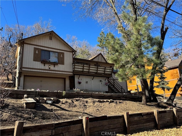 view of front of property with stairway, an attached garage, and fence