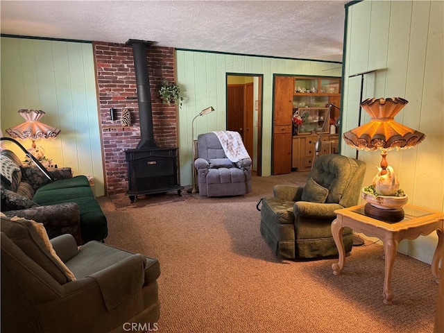 living area featuring a wood stove, carpet, and a textured ceiling