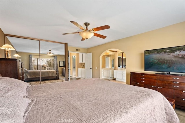 bedroom featuring connected bathroom and ceiling fan