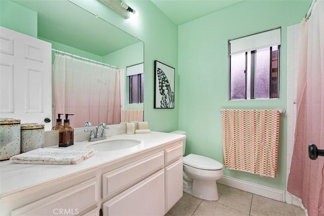 bathroom with tile patterned flooring, vanity, and toilet