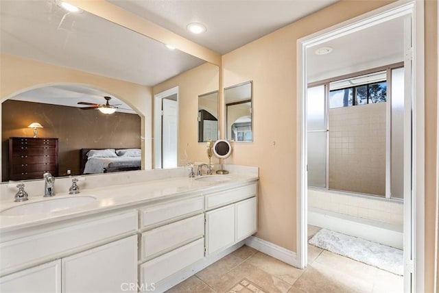 bathroom featuring walk in shower, ceiling fan, vanity, and tile patterned floors