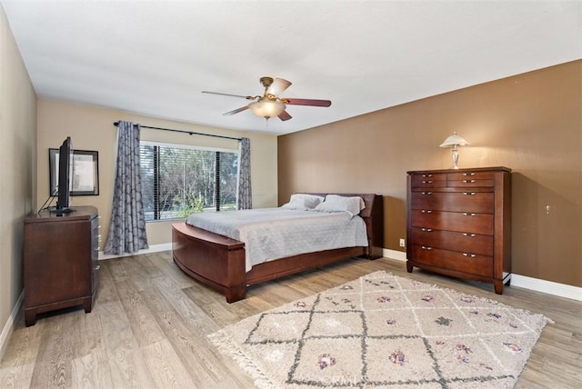 bedroom with light hardwood / wood-style flooring and ceiling fan