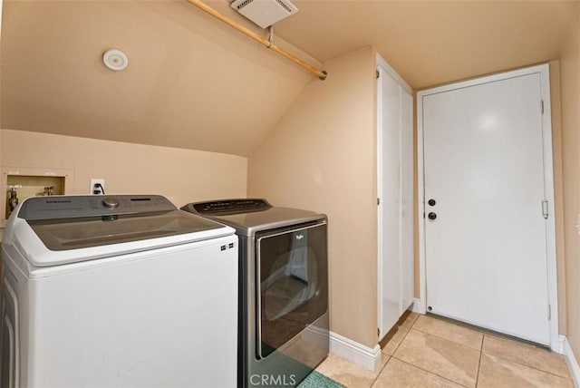 laundry room featuring light tile patterned floors and washing machine and clothes dryer