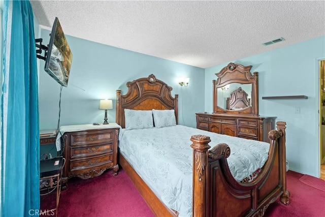 bedroom featuring dark carpet and a textured ceiling