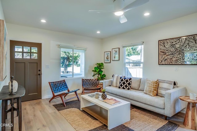 living room with ceiling fan, light hardwood / wood-style flooring, and a wealth of natural light