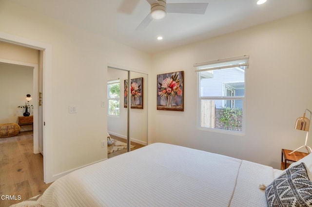 bedroom with a closet, ceiling fan, and light hardwood / wood-style flooring