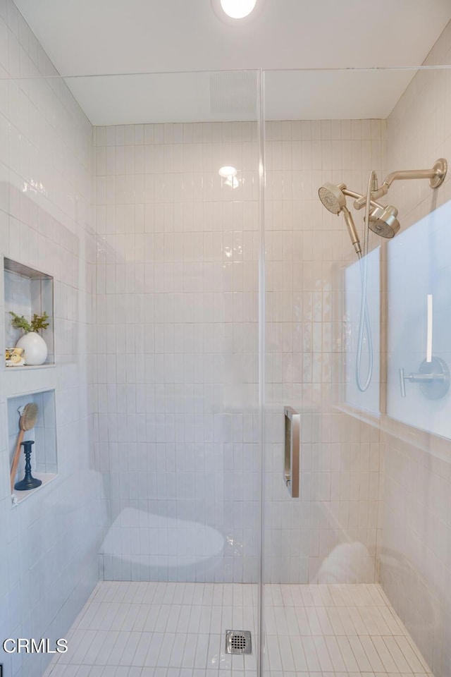 bathroom featuring a shower with shower door