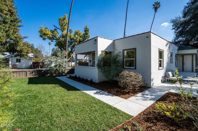 view of side of home with a lawn