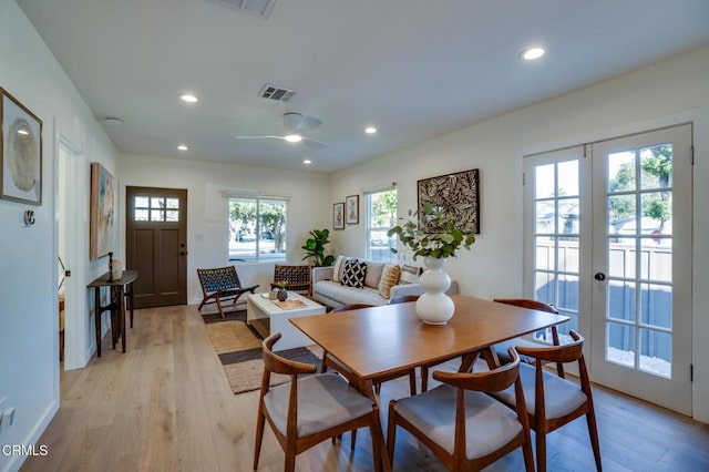 dining area featuring ceiling fan, light wood-type flooring, and french doors