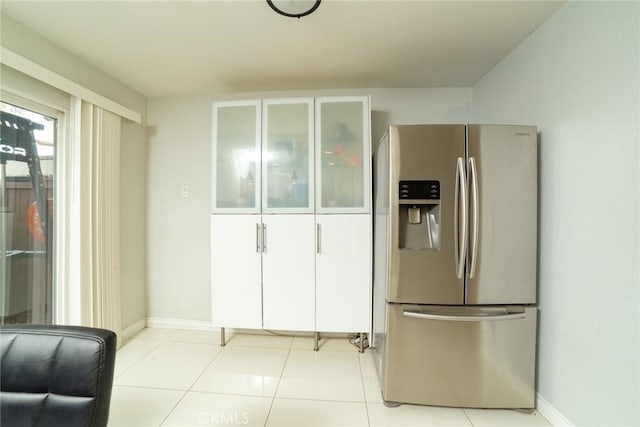 1745 N Winery Ave Unit 102, Fresno, CA 93703 - kitchen with glass insert cabinets, light tile patterned floors, stainless steel fridge, and baseboards
