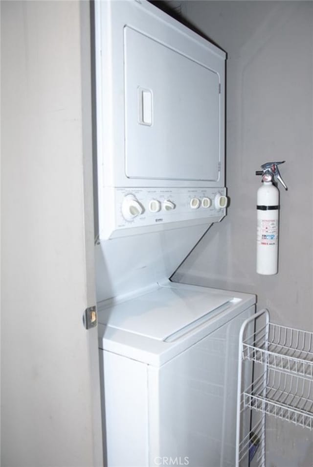 laundry area featuring stacked washer / dryer