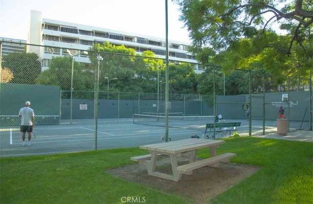 view of sport court with a yard