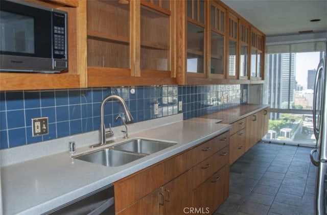 kitchen with sink, backsplash, and a healthy amount of sunlight