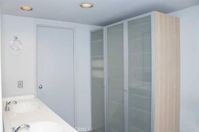 bathroom featuring vanity and a shower