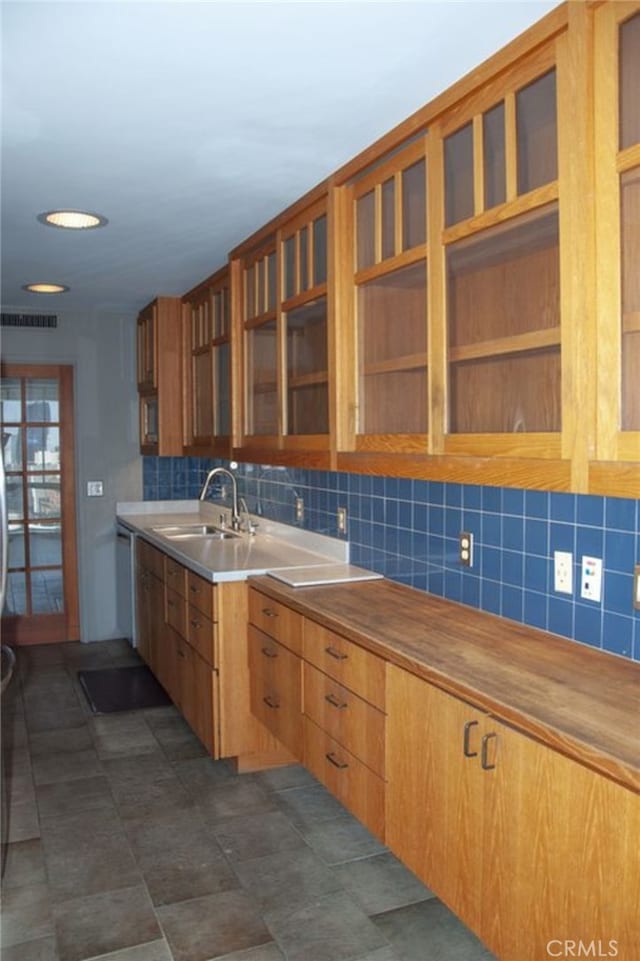 kitchen with butcher block counters, sink, and decorative backsplash