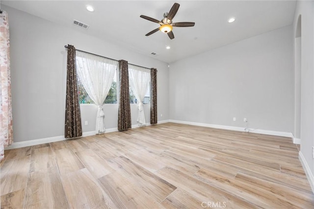 empty room featuring ceiling fan and light hardwood / wood-style floors