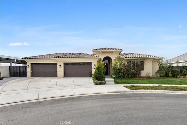 mediterranean / spanish home with a garage and a front yard