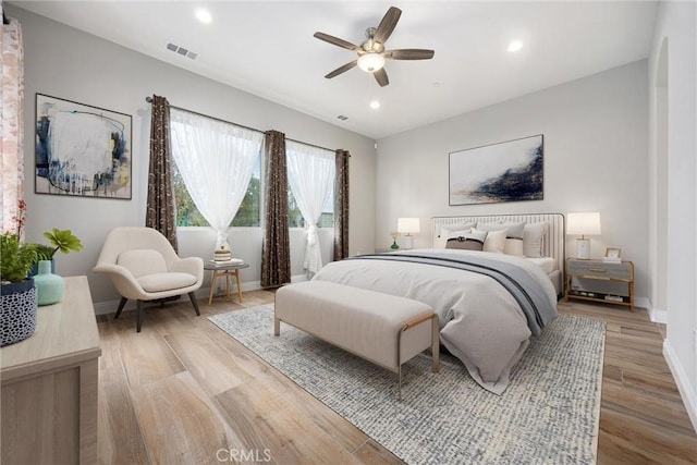 bedroom with light hardwood / wood-style floors and ceiling fan