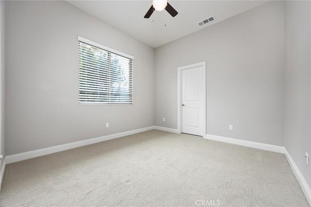 carpeted spare room featuring ceiling fan