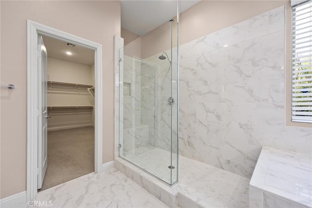 bathroom with a healthy amount of sunlight and tiled shower