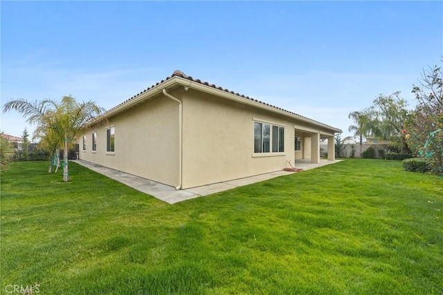 rear view of house featuring a yard