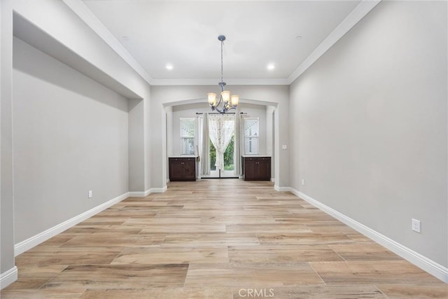 interior space with ornamental molding, light hardwood / wood-style floors, and a chandelier