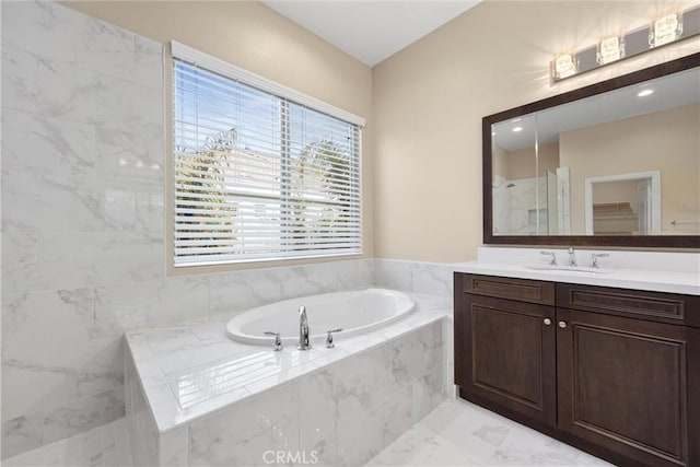 bathroom with vanity and separate shower and tub