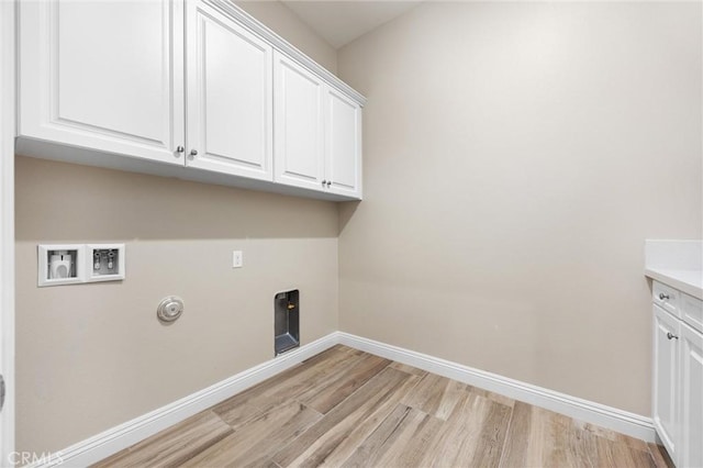 laundry room with cabinets, hookup for an electric dryer, hookup for a washing machine, and light hardwood / wood-style floors