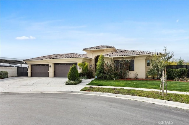 mediterranean / spanish-style home with a garage and a front lawn