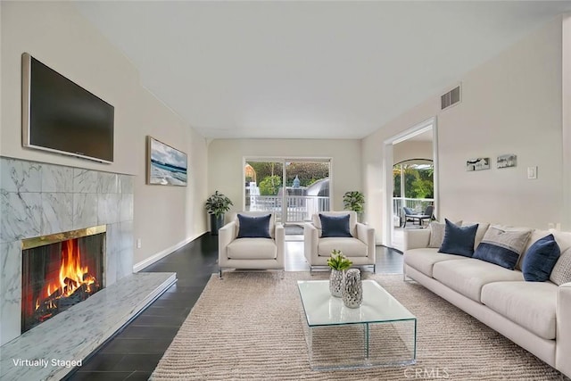 living room with dark hardwood / wood-style flooring and a fireplace