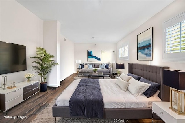 bedroom with dark hardwood / wood-style floors