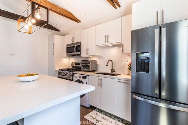 5333 Hartwick St, Los Angeles, CA 90041 - kitchen featuring stainless steel appliances, washer / clothes dryer, light countertops, white cabinetry, and tasteful backsplash