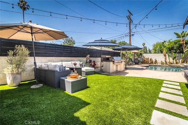 view of yard featuring a fenced in pool, a patio area, an outdoor hangout area, and exterior kitchen