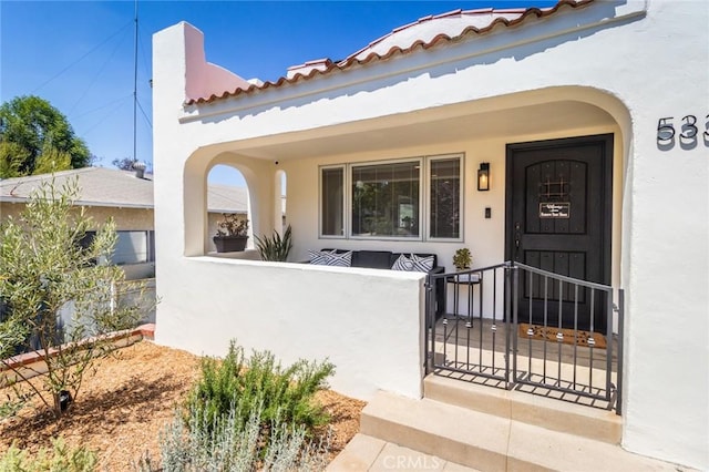 5333 Hartwick St, Los Angeles, CA 90041 - view of exterior entry featuring stucco siding, a gate, and a tile roof