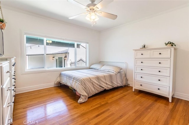 bedroom featuring ceiling fan, ornamental molding, and light hardwood / wood-style flooring