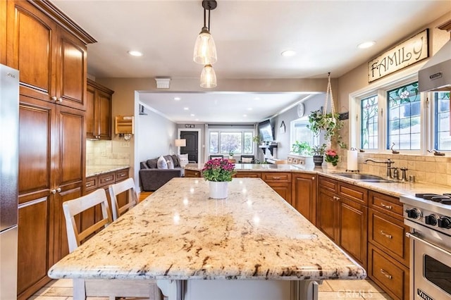 kitchen featuring high end range, a kitchen breakfast bar, and a kitchen island