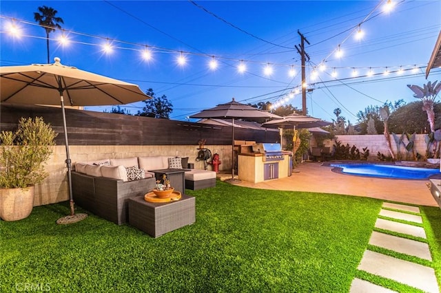 view of yard with a fenced in pool, exterior kitchen, and a patio