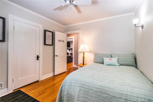 bedroom featuring crown molding, ceiling fan, and hardwood / wood-style floors