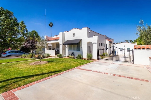 mediterranean / spanish-style home with a front lawn