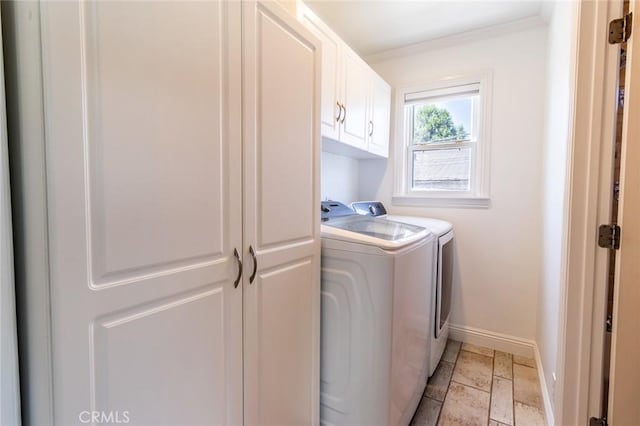 clothes washing area featuring independent washer and dryer, cabinets, and crown molding