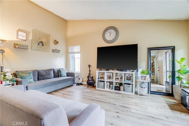 living room featuring vaulted ceiling and light hardwood / wood-style floors