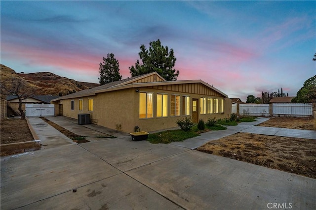 view of front of property featuring cooling unit and a patio