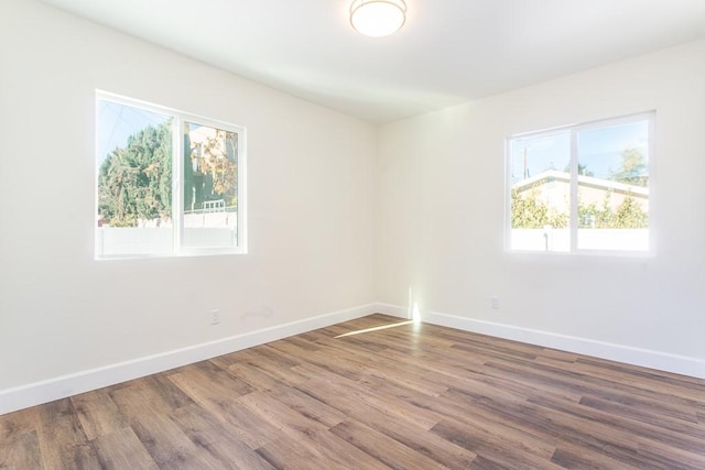 empty room with hardwood / wood-style floors