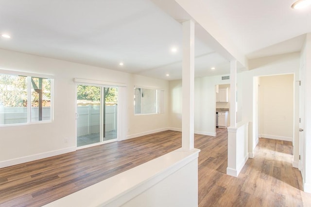 interior space featuring wood-type flooring and beamed ceiling