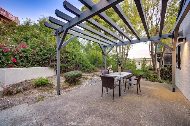 view of patio / terrace with a pergola and outdoor dining space