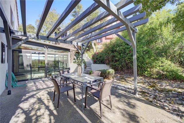 view of patio featuring a pergola and outdoor dining space
