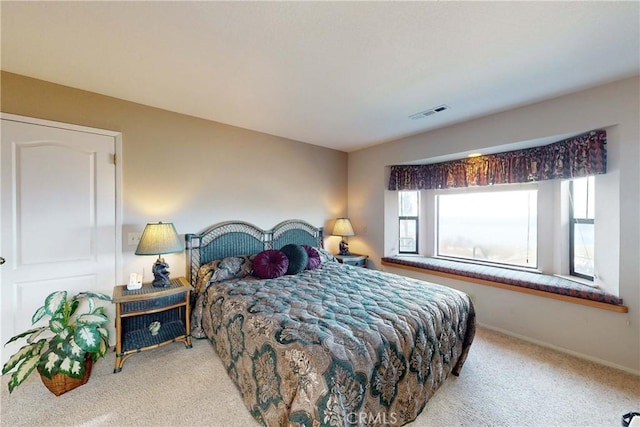 carpeted bedroom with baseboards and visible vents