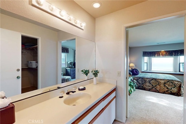 ensuite bathroom featuring connected bathroom and vanity